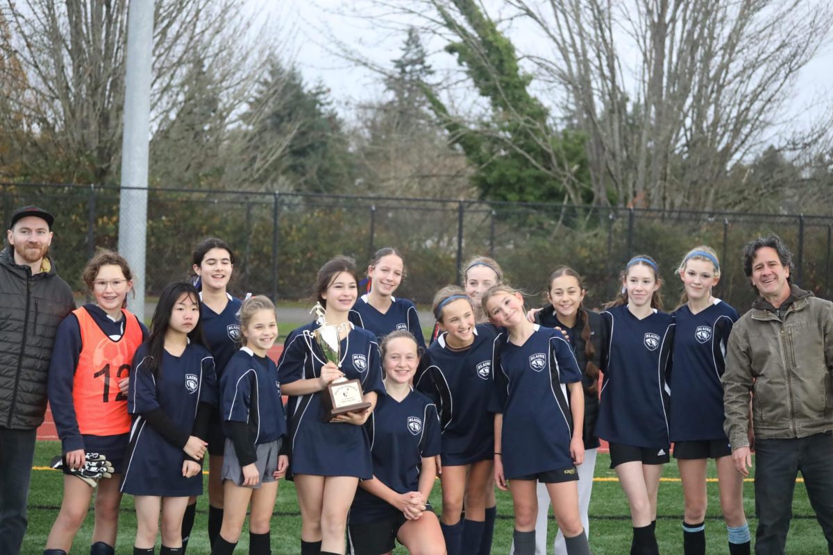 Blaine girls soccer team with trophy from championship win